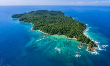 Aerial view of Caño Island Biological Reserve surrounded by turquoise waters near Drake Bay, Costa Rica